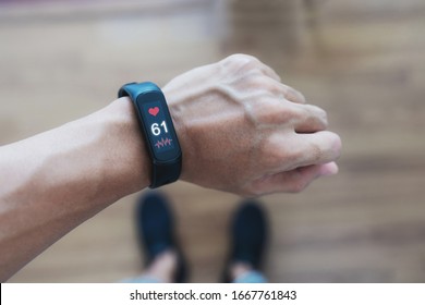 Smart Fitness Tracking And Watch. A Man Using Smart Band Tracking Heart Rate And Health Data