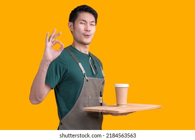 smart friendly asian male glasses barista small coffee shop owner in apron hand gesture welcome customer come and enjoy his coffee drink,happy asia man show coffee with smile and confident studio shot - Shutterstock ID 2184563563