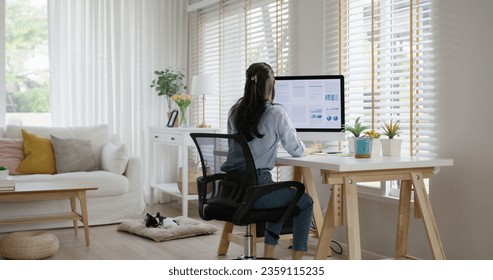 Smart Gen Z tech talent workforce typing SEO sale report on desktop PC happy work easy relax at home office. Remote WFH reskill upskill job MBA study of young people asia woman examine big data graph. - Powered by Shutterstock