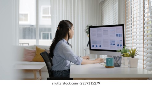 Smart Gen Z tech talent workforce typing SEO sale report on desktop PC happy work easy relax at home office. Remote WFH reskill upskill job MBA study of young people asia woman examine big data graph. - Powered by Shutterstock