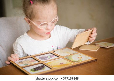 Smart Girl With Down Syndrome Collects Puzzles