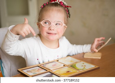 Smart Girl With Down Syndrome Collects Puzzles