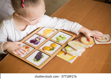 Smart Girl With Down Syndrome Collects Puzzles