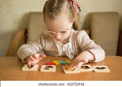 Smart Girl With Down Syndrome Collects Puzzles