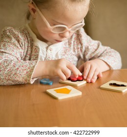 Smart Girl With Down Syndrome Collects Puzzles