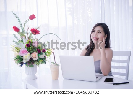 Smart girl's using laptop and happy time on work , smile and laughing time work , workingwomen get think about work