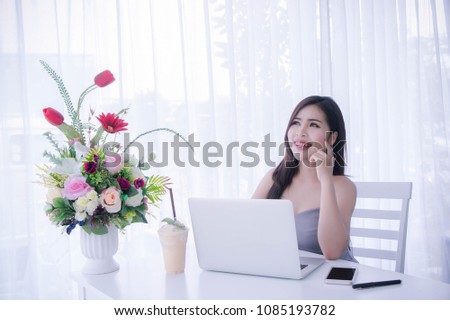 Smart girl's using laptop and happy time on work checking selling online , smile and laughing time work , workingwomen get think about work