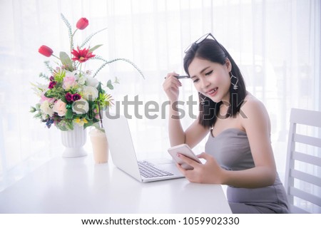 smart girl's using smart phone and working on laptop ,happy time on work, smile and laughing time work , workingwomen get think about work
