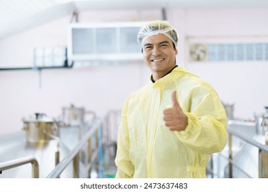 Smart and good looking male supervisor is standing in the food and beverage manufacturing factory and poses to camera. Factory worker portrait in factory. - Powered by Shutterstock