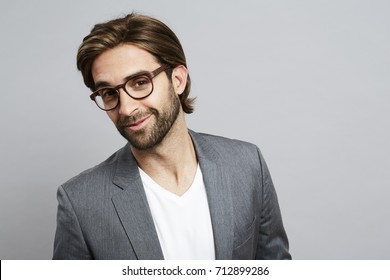 Smart Guy In Spectacles In Grey Studio, Portrait