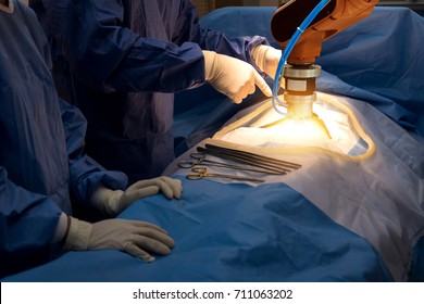 Smart Healthcare Technology , Artificial Intelligence Concept. Selective Focus On Automation Robot Hand Machine In Operating Room And Surgery Doctors In Hospital.