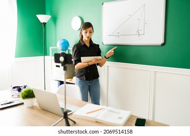 Smart Hispanic Woman Teaching A Math Class To High School Students While Using A Digital Tablet During A Virtual Class