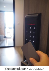 Smart Home Concept, Blur And Out Of Focus A Woman's Holding Keycard For Opening Digital Door Lock And Entry Door Lock In Front Of The Room.