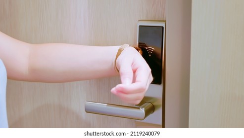 smart home concept - close up of asian woman opens electronic lock by NFC smartwatch