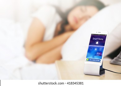 Smart Home Control Concept. Smart Phone Near Bed