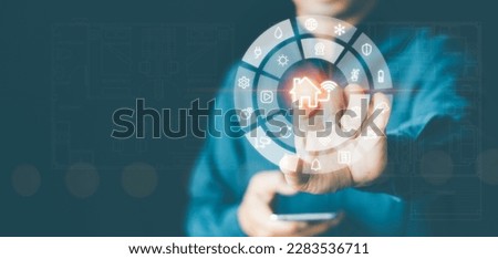 Smart home control interface with finger-touching home automation button on virtual screen dashboard. Wireless connection between smart devices, Internet of Things technology, security and Systems IOT