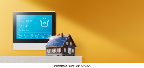 Smart Home Display And Model House With Solar Panel: Smart Home And Energy Efficient Technology Concept