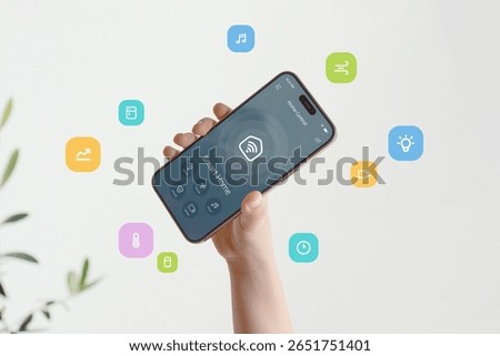 Smart home interface featuring multiple home automation functions visualized through bright graphic elements flying around phone