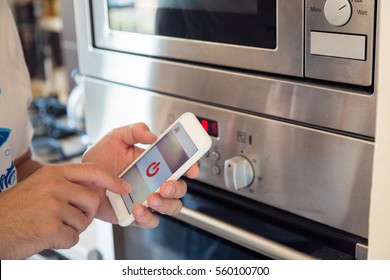 Smart Home: Man Controlling Kitchen With App On His Phone