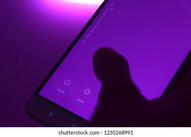 Smart Home: Man Controlling Lights With App On His Phone. Innovation Technology - Shutterstock ID 1235268991