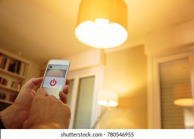 Smart Home: Man Controlling Lights With His Phone