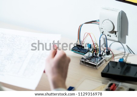 smart home system development. engineer reading schematics before installing automated house control system