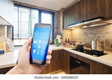 Smart Home System On Mobile Phone With Background Of Modern Kitchen