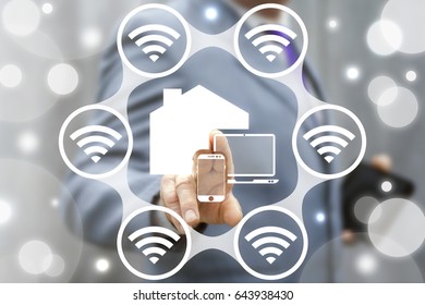 Smart House Concept. Internet Of Things (IoT). Business Man Presses IOT Solution Represented By Symbol Connected With Icons Of Typical IoT. Intelligent Home Management. Control With Wi Fi.