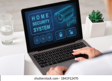 Smart House, Home Automation. Over The Shoulder View Of Woman Using Laptop With Home Security System On The Screen For Remote Control And Surveillance, Lady Monitoring Her Property Online From Work