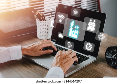 Smart Industry 4.0 Concept, Person Hand Using Laptop Computer With VR Screen Smart Industry Icon, AI, Artificial Intelligence, Automation Robot Arm, Smart Factory.	

