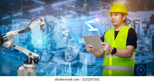 Smart Industry Control Concept.Engineer Hands Holding Tablet On Blurred Robot Arm Automation Machine As Background