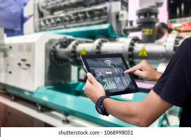 Smart Industry Control Concept.Hands Holding Tablet On Blurred Automation Machine As Background