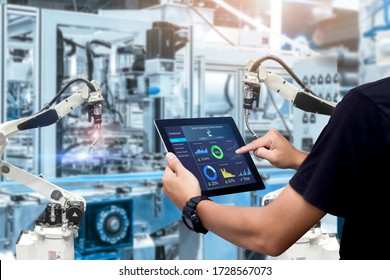 Smart Industry Control Concept.Hands Holding Tablet On Blurred Automation Machine As Background