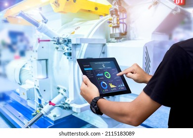 Smart Industry Control Concept.Hands Holding Tablet On Blurred Automation Machine As Background