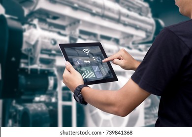 Smart Industry Control Concept.Hands Holding Tablet On Blurred Automation Machine As Background