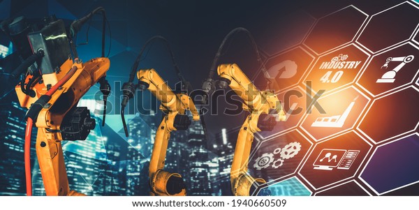 Smart industry robot arms for digital factory\
production technology showing automation manufacturing process of\
the Industry 4.0 or 4th industrial revolution and IOT software to\
control operation .