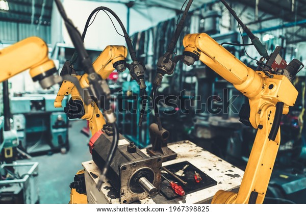 Smart industry robot arms for digital factory\
production technology showing automation manufacturing process of\
the Industry 4.0 or 4th industrial revolution and IOT software to\
control operation .