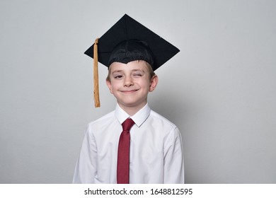 Smart Little Boy In Graduation Hat. Children Education Concept. Middle School, Junior High School.