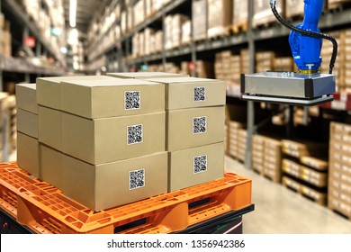 Smart Logistic Industry 4.0 , QR Codes Asset Warehouse And Inventory Management Supply Chain Technology Concept. Group Of Boxes And Automation Robot Arm Machine In Storehouse