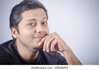Smart looking Asian indian male with close up with charming expression.