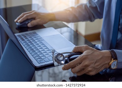 Smart Male Doctor Hand Using Wireless Mouse,search Medical Information On Laptop Computer At Office. Medic Tech, Telehealth , Online Medical,  Teleconference Or Telemedicine Concept. 