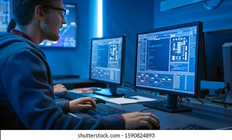Smart Male IT Programer Working on Desktop Computer. Software Development / Code Writing / Website Design / Database Architecture. Technical Department Office.