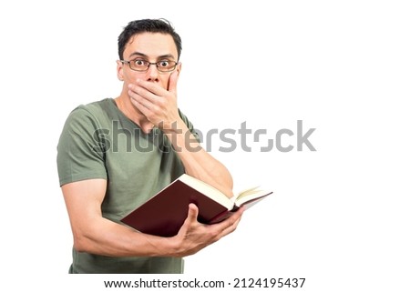 Smart man in glasses reading shocking book