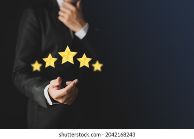 A smart man in a suit who is deciding to give a star rating.-customer experience concept Excellent service, the best for satisfaction.tif
