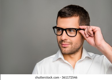 Smart Man  Touching His Glasses And Looking Ahead