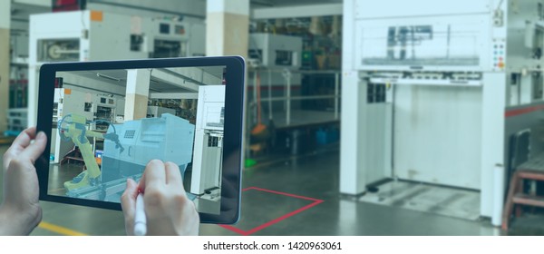 smart manufacturing ,industry 4.0, 5.0 technology concept, man use augmented mixed virtual reality technology to manage and simultion to install new machine in the factory predict, analytic how to fit - Shutterstock ID 1420963061