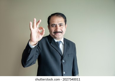 Smart Mature Older Business Man With Moustache Showing A OK Sign With His Hand Wearing Suit And Tie