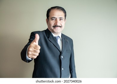 Smart Mature Older Business Man With Moustache Showing A Thumbs Up Wearing Suit And Tie 