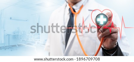 Smart medicine doctor and stethoscope in hand touching heart rate icon with modern virtual screen interface,healthcare medical,Insurance for your health concept.
