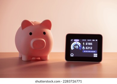 Smart meter, energy meter. Checking domestic electricity and gas use. Smart meter reading over budget. Piggy bank, savings. - Shutterstock ID 2283726771